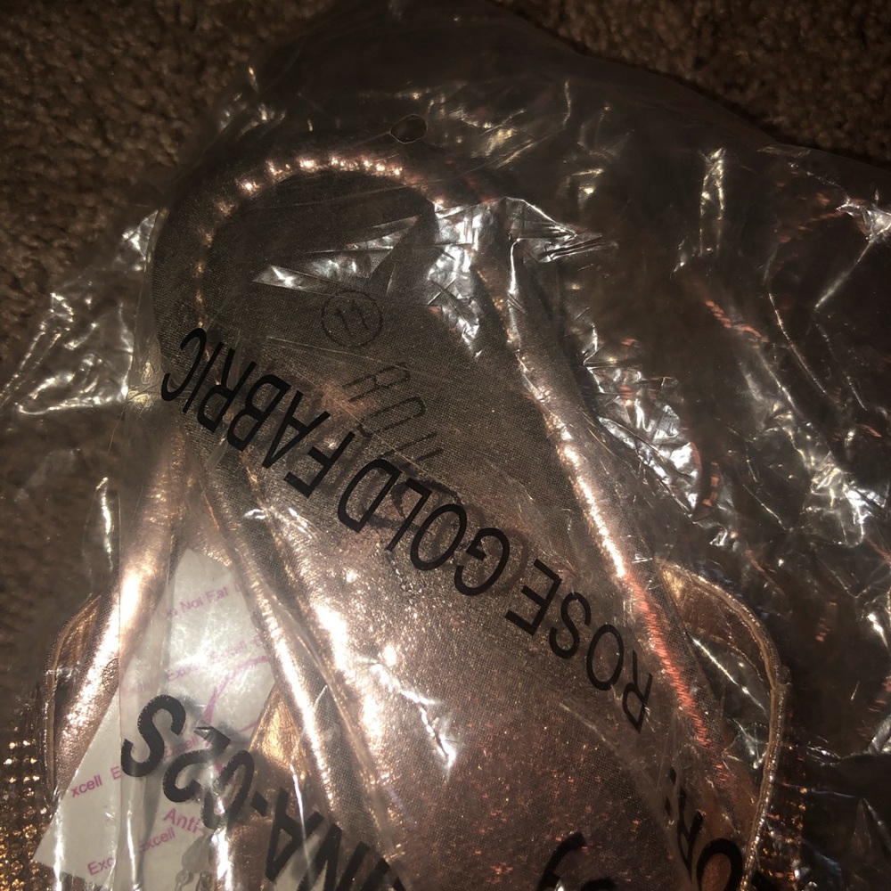 Still in package gold flip flops.